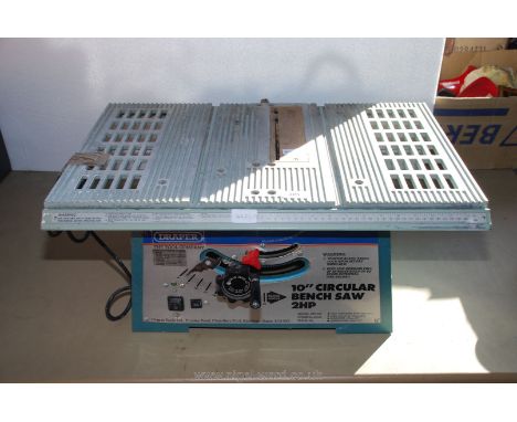 A Draper electric 2 H.P. 10'' bench-top circular saw with rise &amp; fall and tilt blade.