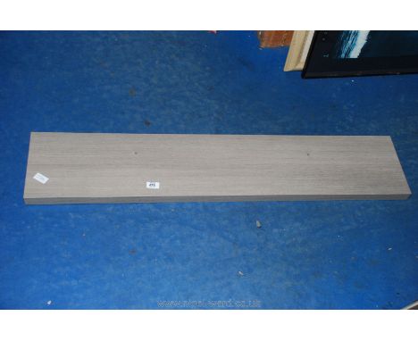 A grey wood-grain finished floating shelf, 46'' x 9''.