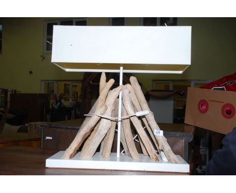 An artistic driftwood feature twin-light table lamp and shade.