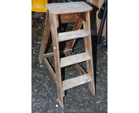 A set of three-rung fixed step ladder.