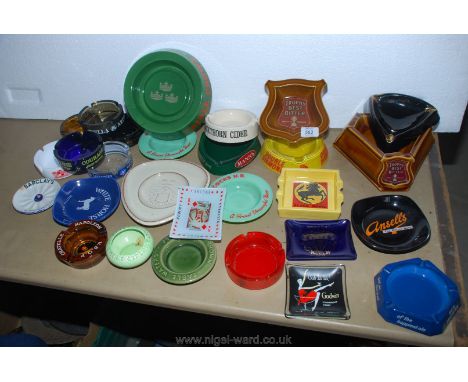 A crate of ceramic and glass trade advertising tavern ashtrays including a Guinness tricorn shaped ash-tray.