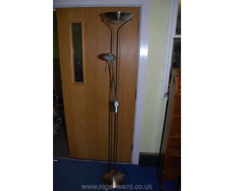 A contemporary floor-standing up-lighter combined with an adjustable reading/work light.