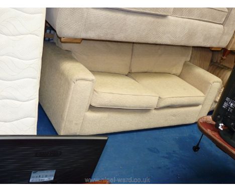 Two/three seater fire-proof cream coloured upholstered sofa.