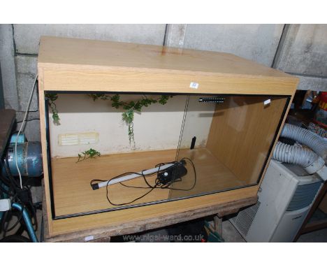 A terrarium for animals with light. 47" x 30" x 24".