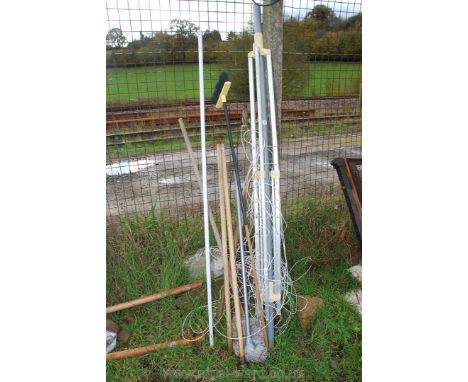 A Rotary clothes line, mops brush and miscellaneous handles.