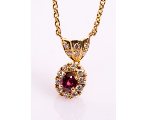 A ruby and diamond cluster pendant necklace, the oval cluster beneath a diamond set bail to an 18ct yellow gold chain, gross 
