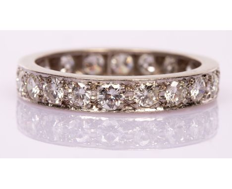 A diamond eternity ring set with twenty brilliant cut stones in a platinum mount, total diamond weight approximately 1.5ct, s