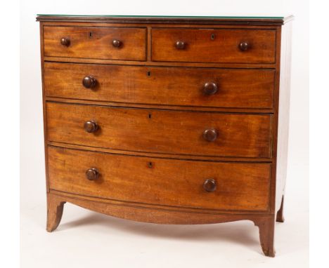 A Regency mahogany bowfront chest of two short and three long graduated drawers, on splay bracket feet, with glass top, 110cm