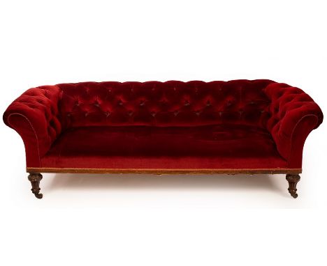 A Victorian Chesterfield sofa, on turned fluted front legs with castors, one back leg stamped G Thomson, 210cm wide, 95cm dee