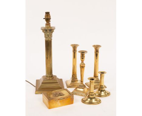 A brass reading lamp with a Corinthian column, three brass candlesticks on square bases, another pair on oval bases and a cig