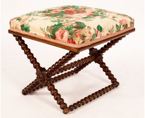 A mid 19th Century bobbin-turned beech frame stool, the rectangular padded seat on X-shaped support, 49cm wide/Provenance: fr