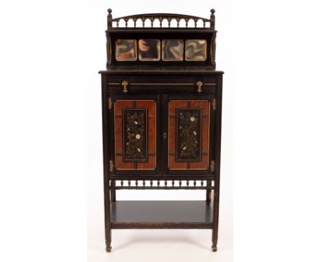 An Aesthetic movement ebonised cabinet, by G Davis, late J Yabsley's, Plymouth, the galleried crest above a mirror back, the 