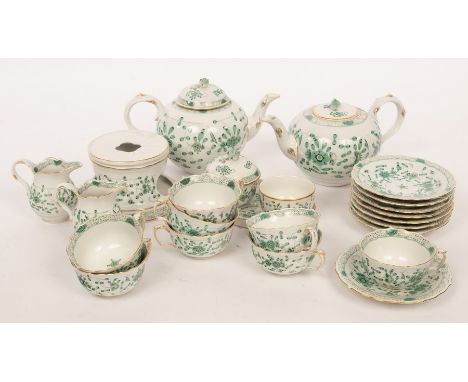 A modern Meissen tea service for eight decorated in the Indian green pattern, comprising two teapots, a warming stand with bu