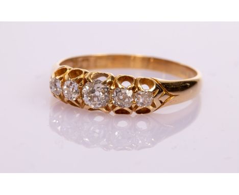 A Victorian five-stone diamond ring in an 18ct yellow gold scroll setting, the graduated rose cut diamonds totalling approxim