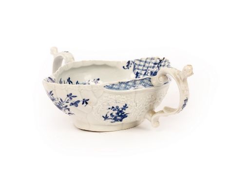 A Worcester blue and white double-lipped sauce boat, circa 1755-58, modelled with shell-shaped lips, leaf scroll roundels and
