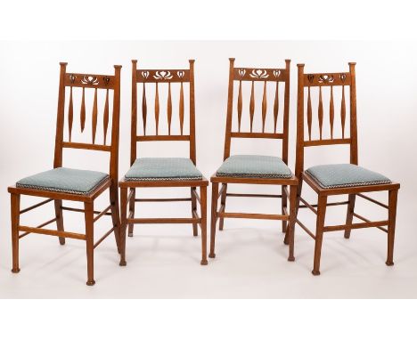 A set of four Art Nouveau oak dining chairs, with pierced crest rails and spindle backs, stamped under K 190 CONDITION REPORT