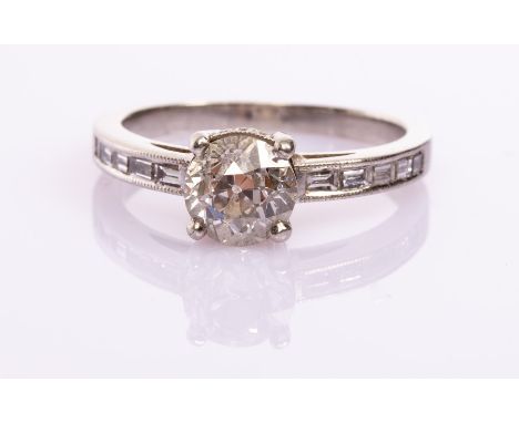 A diamond solitaire ring, the old cut diamond of approximately 1.60ct claw set to a platinum shank with line of five baguette