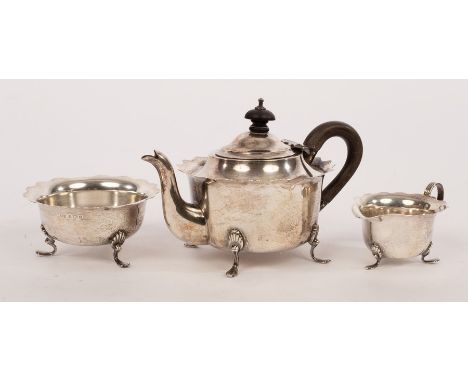 A silver three-piece tea service, WD, Birmingham 1903, with flanged borders raised on three feet, approximately 370gm CONDITI