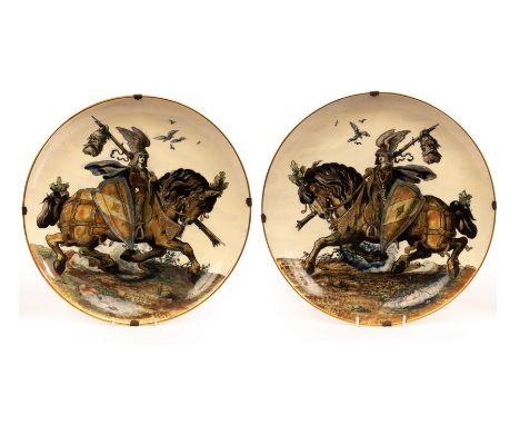 A pair of Zsolnay Pecs porcelain chargers, perhaps depicting the boy king Matthias Corvinus of Hungary, depicted astride a ch