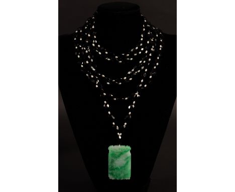 Catherine Prevost, a six-row necklace of faceted black beads with freshwater pearl spacers, centred by a rectangular jade pen