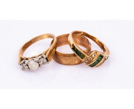 An opal and diamond three-stone ring, maker CG&amp;S, set in 18ct yellow gold, size L½, an emerald and diamond dress ring, ma