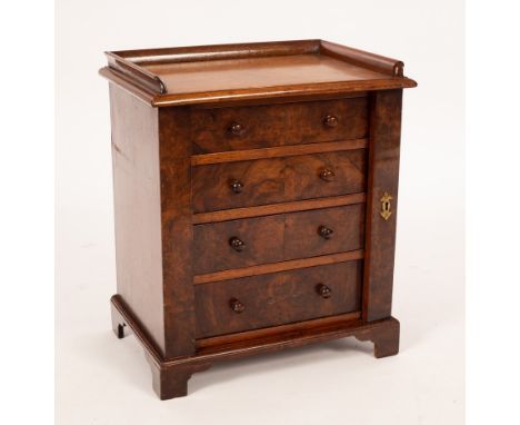 A small Regency mahogany Wellington chest, the top with three-quarter gallery, fitted four drawers with a locking pillar to t