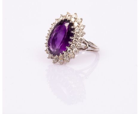 An amethyst and diamond oval cluster ring, the amethyst with double border of diamonds to an 18ct white gold mount marked PJW