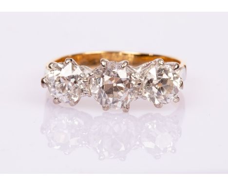 A diamond three-stone ring, the three old brilliant cut stones of 1.13ct, 0.64ct and 0.68ct, claw set to an 18ct yellow gold 