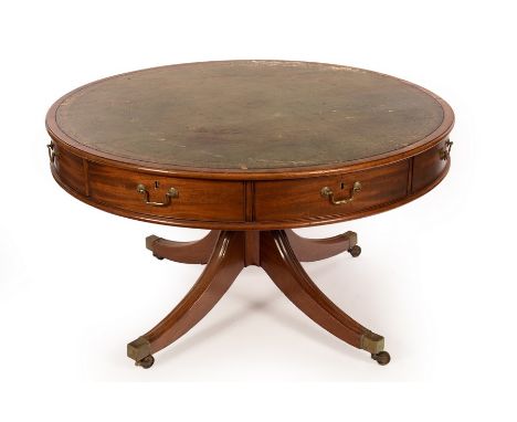 A mahogany circular drum library table, the moulded top with replacement leather inset, four frieze drawers and four dummy dr