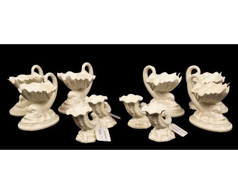 Six Royal Worcester pearlware sweetmeat dishes in the form of a shell with dolphin supports, 11.5cm high and four Royal Worce