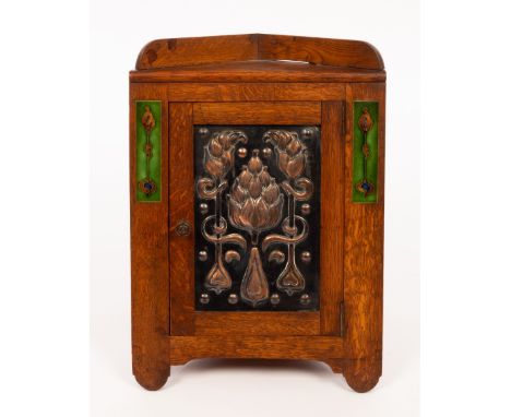 An Art Nouveau oak, copper and enamel smokers corner cabinet, 54cm high CONDITION REPORT: Lot 548 - Left hand pillar enamel s