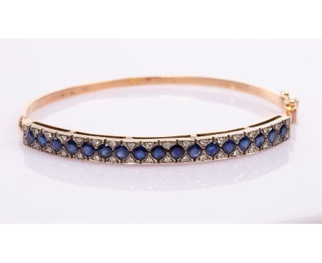 A sapphire and diamond hinged bangle, set in 14ct yellow gold, Italian assay mark, internal size 6cm x 5cm, approximately 15g