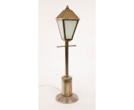 An Arts &amp; Crafts style table lamp, in the form of a Victorian street light on a hammered metal stepped base, 65cm high