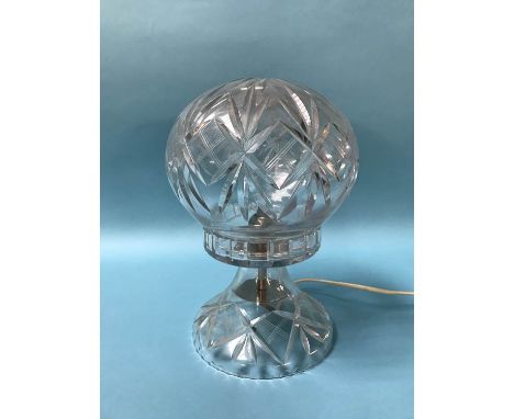 A cut glass table lamp and shade