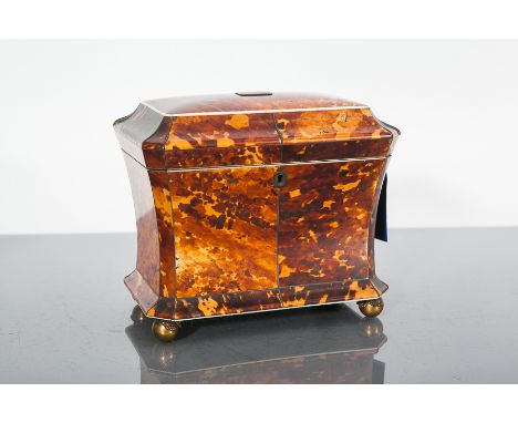 ATTRACTIVE REGENCY TORTOISESHELL TEA CADDY 
of concave form, the hinged cover applied small silver tablet and enclosing two l