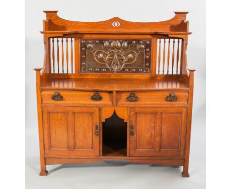 ATTRACTIVE ARTS AND CRAFTS OAK SIDEBOARDthe raised back with an open shelf, inset Glasgow School embossed copper panel below 