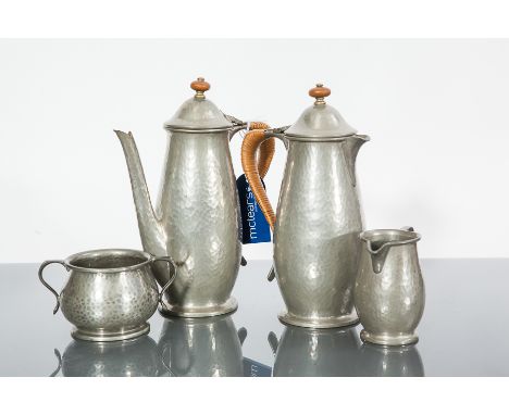 TUDRIC PEWTER COFFEE SERVICE
comprising a coffee pot, water pot, sugar and cream, each with wooden finial and wicker handle, 