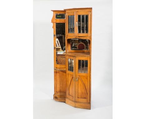 EDWARDIAN OAK CORNER HALLSTAND
the angled cupboards enclosed by mirrored panel door separated by an open recess, stick stand,