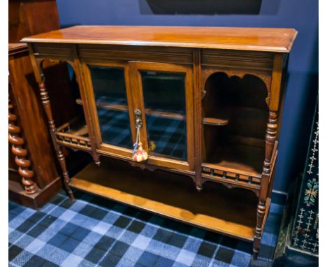 EDWARDIAN CARVED LIGHT MAHOGANY SIDEBOARD
with double rectangular glazed doors flanked by open shelves, on tapered legs, form