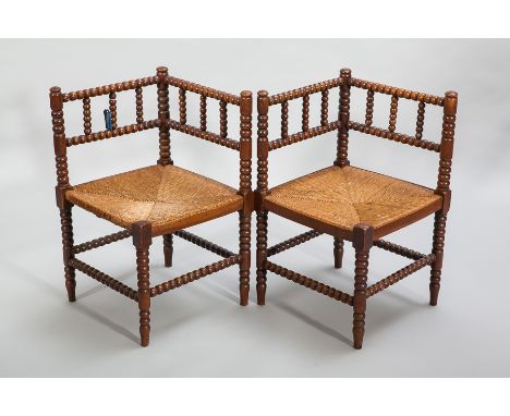 PAIR OF VICTORIAN OAK BOBBIN TURNED CORNER CHAIRS
with rush seats and bobbin turned stretchers, 70cm high (2)