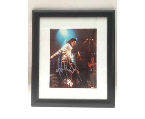 A framed and glazed signed photo of Michael Jackson, approx 34cm x 39cm. Comes with a COA from a UACC registered member.