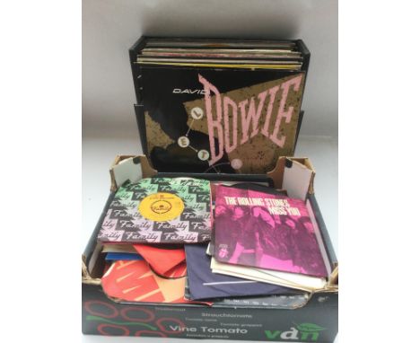A record case of 12inch singles and a box of 7inch singles by various artists including David Bowie, Madonna, Michael Jackson