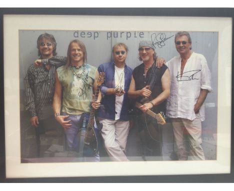 A framed and glazed Deep Purple poster signed by the band, approx 77cm x 56cm. Comes with a 2007 concert ticket.