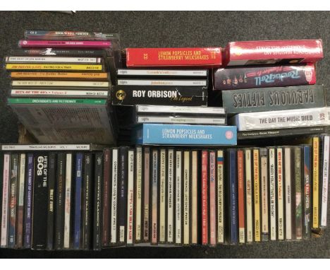 A box of CDs by various artists including Buddy Holly, Billy Fury, Patsy Cline and others.