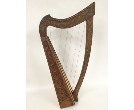 A Celtic harp with soft carry case.
