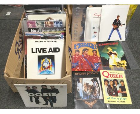 A box of tour brochures and calendars for various artists including Michael Jackson, Prince, Oasis, Queen and others, some wi