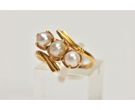 A YELLOW METAL CULTURED PEARL THREE STONE RING, of openwork design, comprising two split and one cultured pearl replacement, 