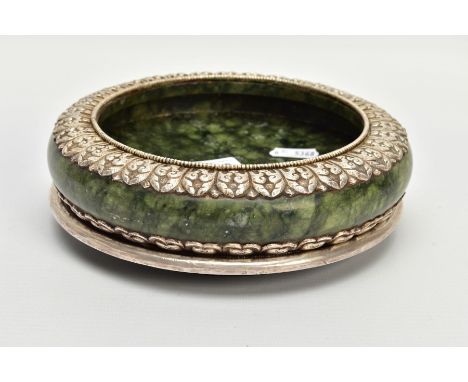 A WHITE METAL JADE BOWL AND STAND, believed to be 'Serpentine Jade,' with a white metal decorative foliate surround, unmarked