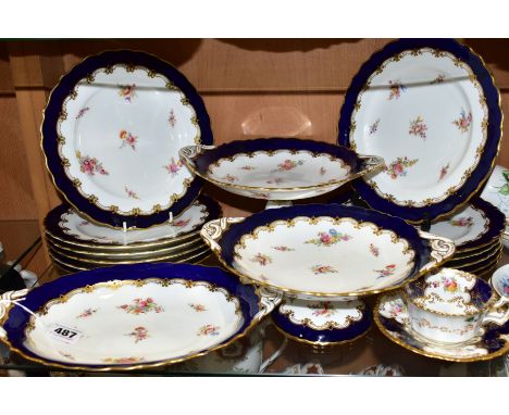 AN EARLY 20TH CENTURY COALPORT DESSERT SERVICE, with wavy gilt rim, blue border surrounding a gilt edged printed and tinted f