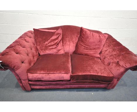 A DFS RED UPHOLSTERED SOFA, with buttoned armrests, length 204cm x depth 110cm x height 90cm